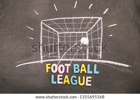 Drawing of goal post of soccer play with white chalk on blackboard. 