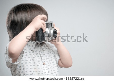 Kid with old photo camera 