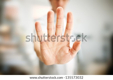 Man showing stop gesture Royalty-Free Stock Photo #135573032