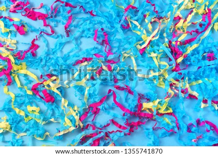 Decorative abstract background of colored paper on a blue background. Top view