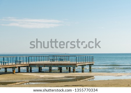 Old wooden empty pier on the beach. Larnaca, Cyprus