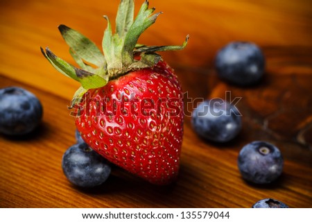 strawberry and blueberries on a wood table