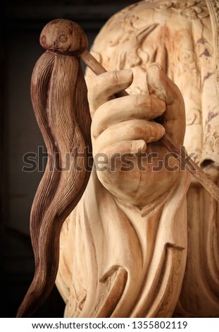 Hand of an ancient Buddha image made of carved wood.used for website banners,leave space for logos