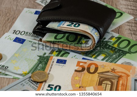 euro purse with money on wooden background close up