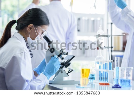 Asian scientist team has researching in laboratory. Royalty-Free Stock Photo #1355847680