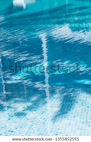 Water surface texture with palm reflection