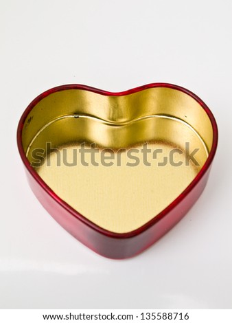 A red stainless steel heart box isolated on white