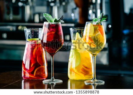 White and red sangria with fruit and ice. Summer alcohol drink and ingredients. sangria with red and white wine Royalty-Free Stock Photo #1355898878