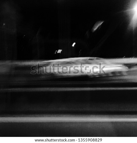 Cars going fast on a expressway. Blurry motion image of cars moving fast on the way. Black and White picture.