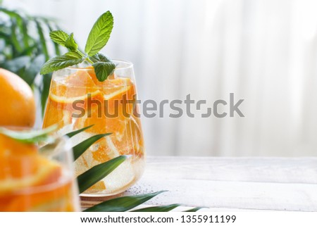 Homemade refreshing drink with soda and orange juice close up