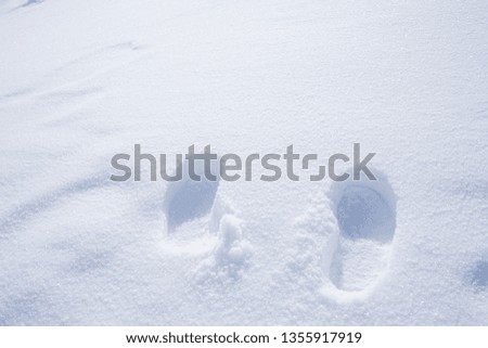 The picture of footprints or foot step on the snow.