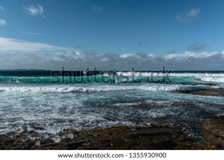 waves in the ocean and blue sky