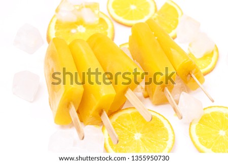 Tasty Homemade Popsicles with Orange Juice Ice Fruit Lollies on Sticks Ice Cube Top View Flat Lay Horizontal White Background Orange Ice Cream