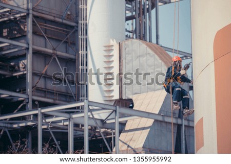 Focus male worker using rope access of inspection storage tank