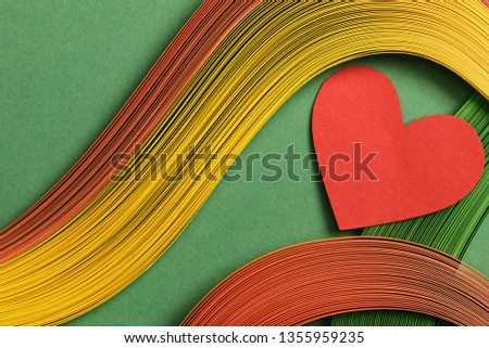 top view of multicolored abstract lines on green background with red heart sign