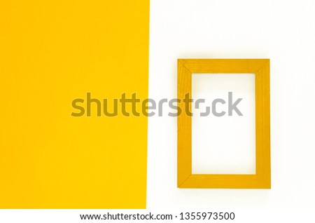 Yellow wood frame isolated on white background with yellow paper. Flat lay template