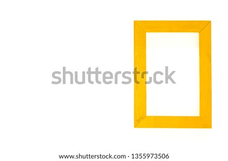 Yellow wood frame isolated on white background with yellow paper. Flat lay template