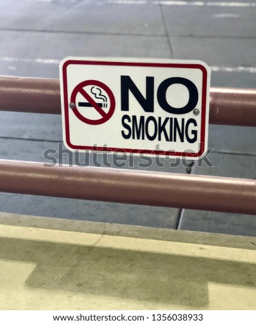 No smoking allowed - sign hanging out exterior railing