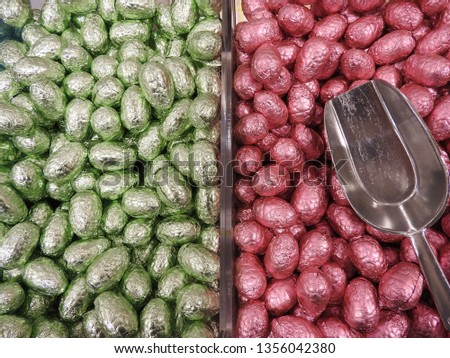 Close up of chocolate easter or pachal eggs and scoop. Beautiful colors, pink and green, background picture.Typical dutch tradition. Gift on the occasion of Easter.