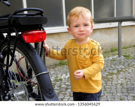 little boy near the bike