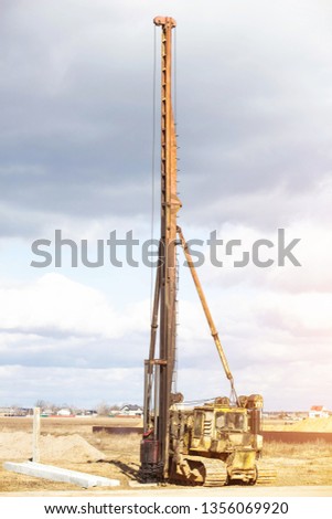 Construction and construction of the foundation on reinforced concrete driving piles in poor soil, equipment for driving piles, diesel hammer, copra, moisture resistance Royalty-Free Stock Photo #1356069920
