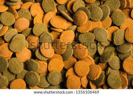 granulated food for aquarium fish on white background