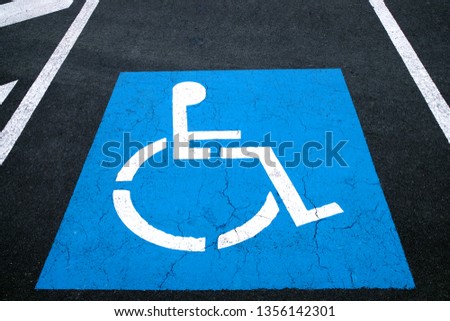 International Wheelchair Symbol, asphalt parking lot.