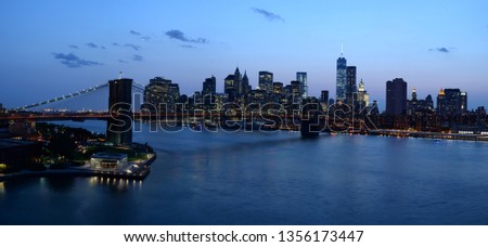 Dusk view of New York landmark and Manhattan reflecting in water