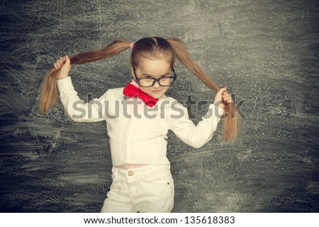 Beautiful smiling girl on a black background. School concept