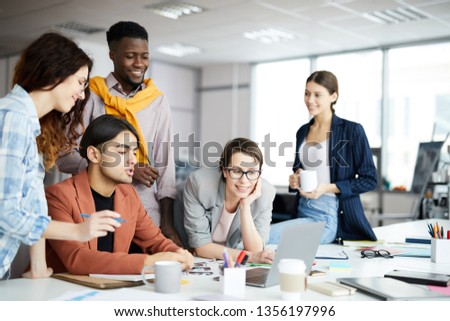 Portrait of multi-ethnic business team collaborating on project in modern office, copy space