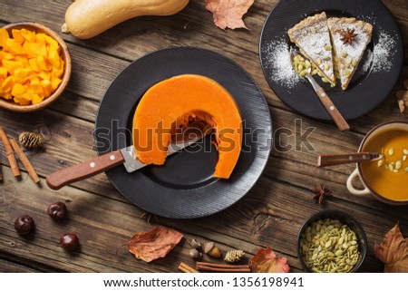 pumpkin dishes on old wooden background