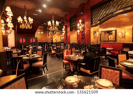 beautiful restaurant with a romantic couple eating Royalty-Free Stock Photo #135621509