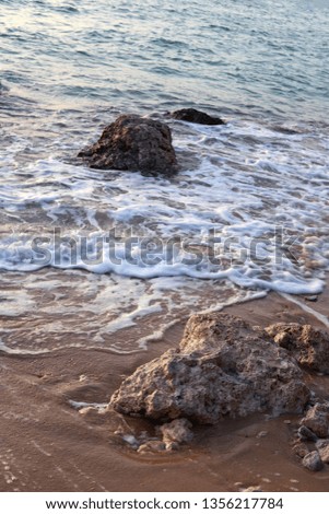 The rock in the water on the beach of the red sea Royalty-Free Stock Photo #1356217784