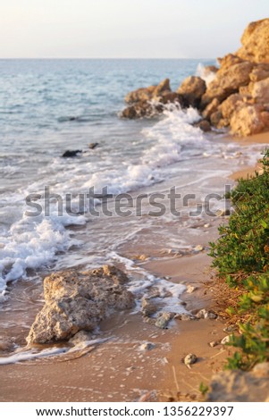 Waves breaking on rocks  Royalty-Free Stock Photo #1356229397