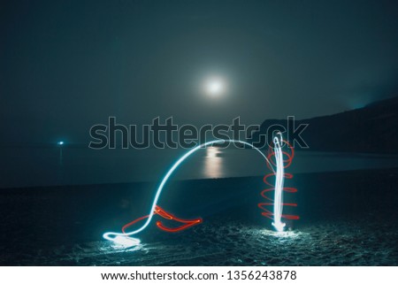 light paint abstract art drawings by the beach 