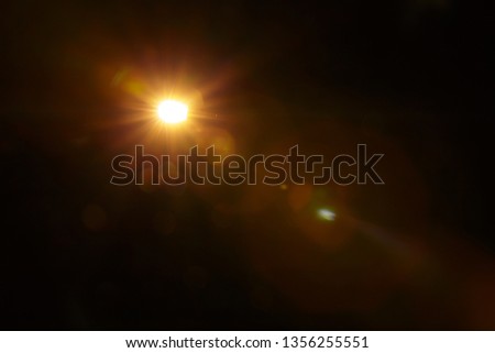 Abstract Natural Sun flare on the black Royalty-Free Stock Photo #1356255551