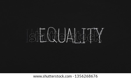 Word Equality written with white chalk on blackboard, panorama