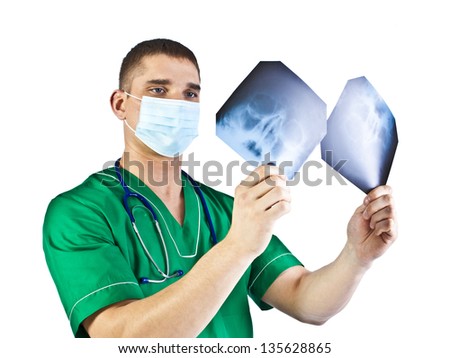 Friendly elderly doctor holds radiograph x-ray image in hands  in green uniform . Isolated on white background.