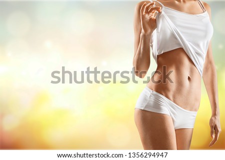 Health and beauty - woman in cotton underwear showing slimming concept