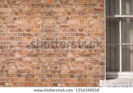 red brick wall texture with a window Royalty-Free Stock Photo #1356340058