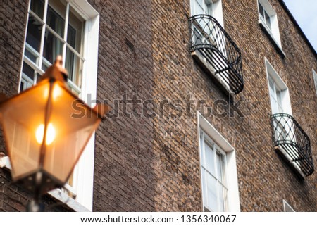 moody brick Wall texture with a street lamp Royalty-Free Stock Photo #1356340067