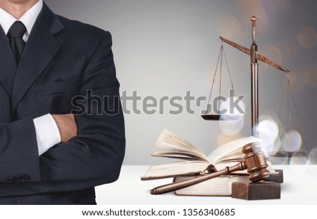Lawyer standing with crossed arms, Scales of Justice on the background