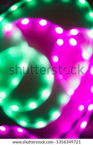 Abstract background of blurred neon green and purple lines. Trend of 80s colors.