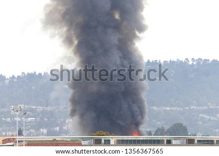 Smoke and flames shooting up from Oakland, CA warehouse fire April 1, 2019. Viewed from Alameda Island approx a mile away