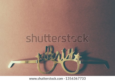Party glasses golden over a brown background, top view, flatlay,