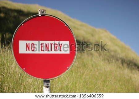 Red No Entry Sign with Grass Field background 