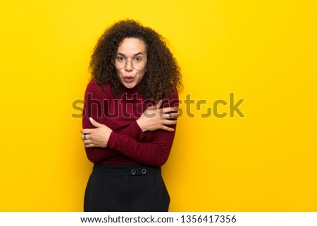 Dominican woman with turtleneck sweater freezing