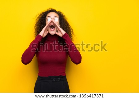 Dominican woman with turtleneck sweater shouting and announcing something