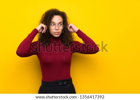 Dominican woman with turtleneck sweater having doubts and thinking