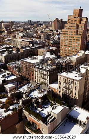 High angle view to the west at the snow covered rooftops of the West Village in Manhattan, on a lovely sunny day.